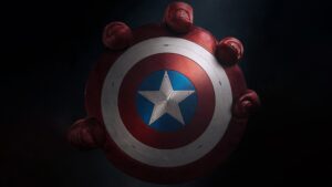 A close-up of Captain America's shield from Captain America: Brave New World, showcasing its iconic star emblem surrounded by fists symbolizing strength and unity.