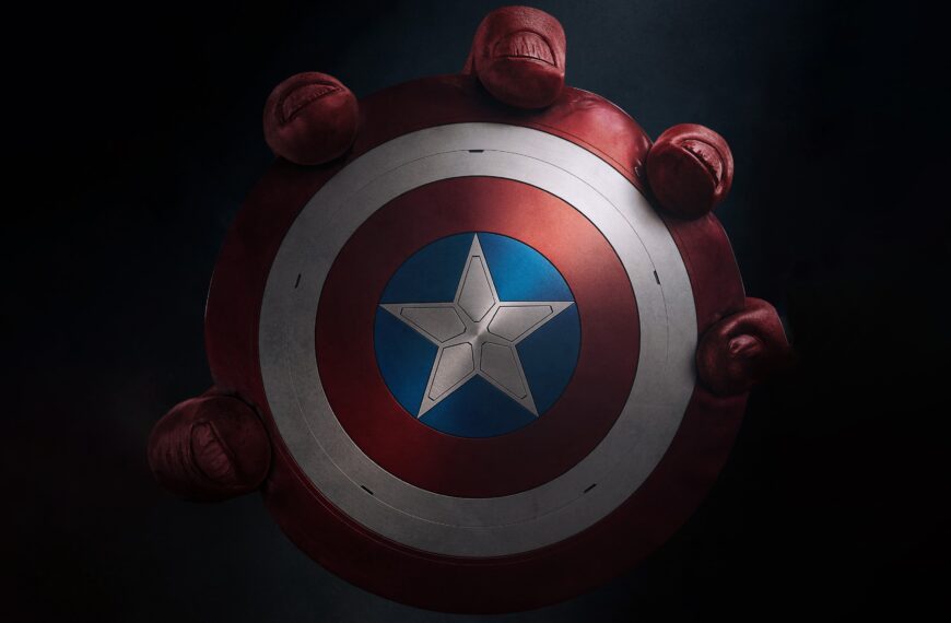 A close-up of Captain America's shield from Captain America: Brave New World, showcasing its iconic star emblem surrounded by fists symbolizing strength and unity.