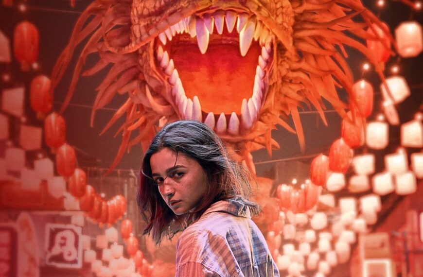 A woman standing in front of a fierce dragon, setting the tone for the suspenseful movie Jigra.