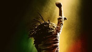 "Bob Marley raising his fist in triumph, symbolizing strength in Bob Marley: One Love."