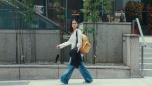 A woman walking confidently in the city in Jigra, representing her journey in the movie.