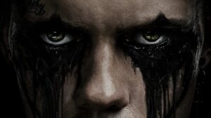 Close-up of the lead character in The Crow 2024 with intense, dark eye makeup.